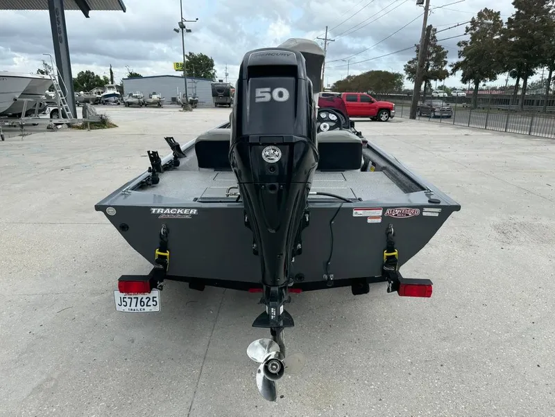 Slide: The Image of 2018 Tracker Pro 170 boat with 50 HP motor, parked outdoors. - 8