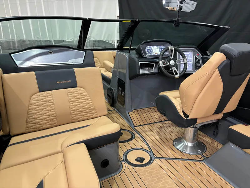 Slide: The Image of 2023 MasterCraft X24 boat interior with tan leather seats and modern dashboard. - 11