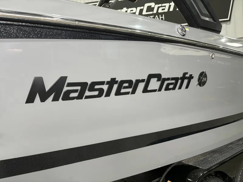 Slide: The Image of 2023 MasterCraft X24 boat side view with logo in showroom. - 3