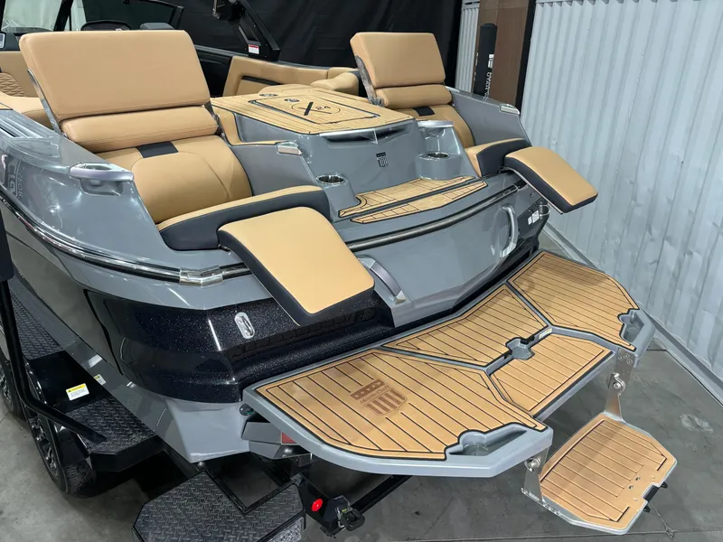 Slide: The Image of 2023 MasterCraft X24 boat with tan seating and teak swim platform. - 6