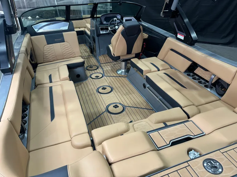Slide: The Image of 2023 MasterCraft X24 boat interior with luxurious tan seating and modern dashboard. - 7