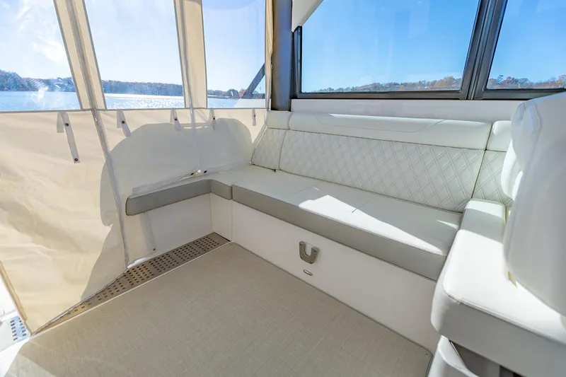 Slide: The Image of Luxurious interior of 2021 Regal 36 Grande Coupe yacht with white seating and scenic view. - 13