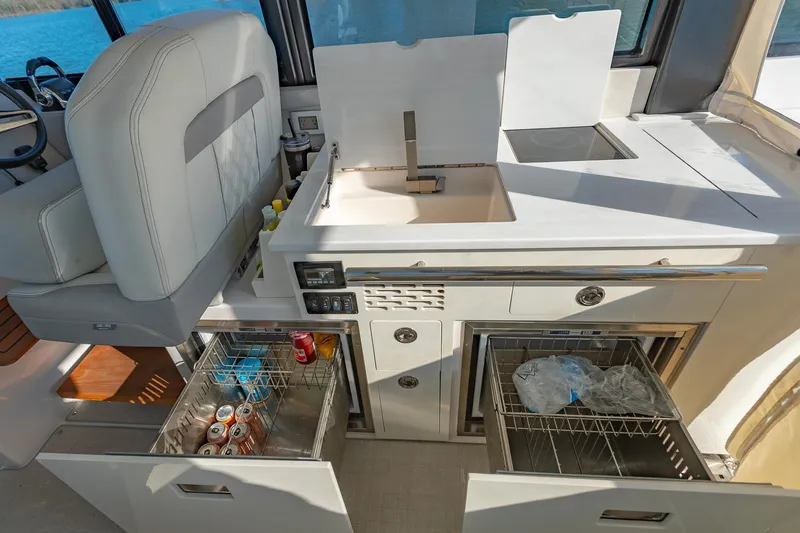 Slide: The Image of 2021 Regal 36 Grande Coupe yacht interior kitchen with sink and storage drawers. - 15