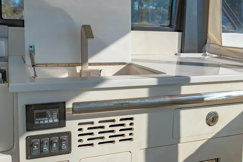 Slide: The Image of 2021 Regal 36 Grande Coupe yacht kitchen with modern sink and control panel. - 16