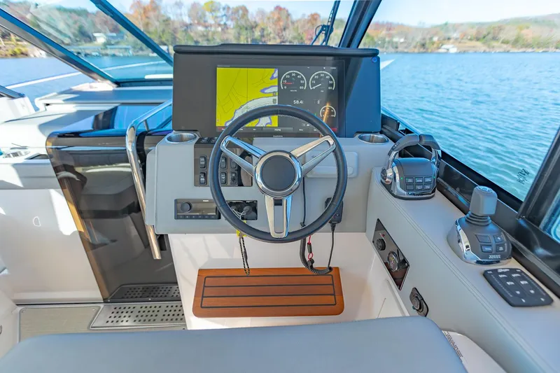 Slide: The Image of 2021 Regal 36 Grande Coupe helm with modern controls and navigation display. - 20