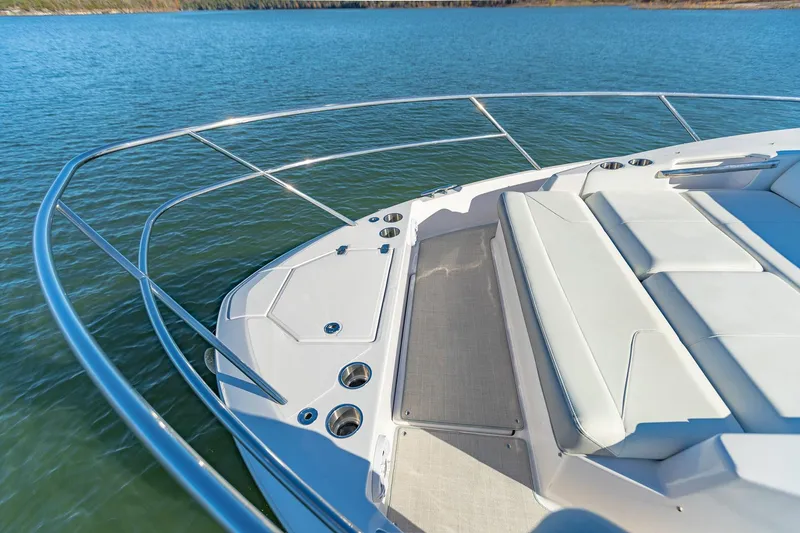 Slide: The Image of 2021 Regal 36 Grande Coupe boat deck with seating, on calm water. - 25