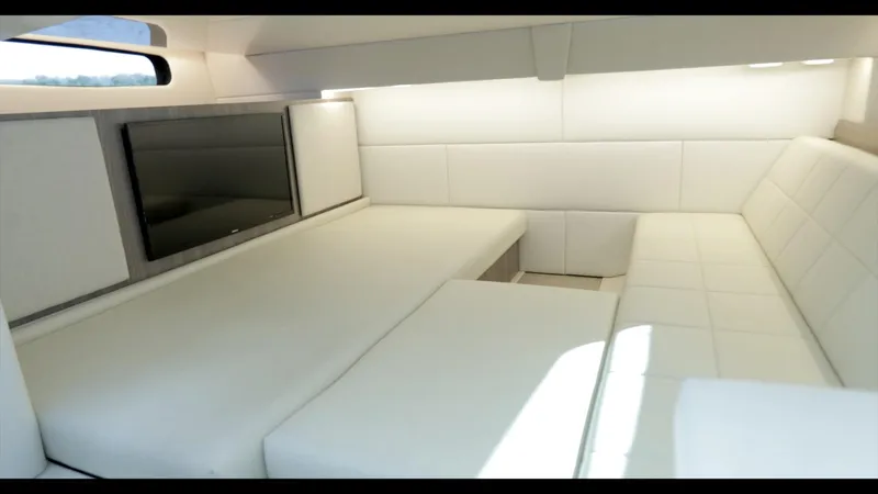 Slide: The Image of Luxurious interior of 2021 Regal 36 Grande Coupe with white seating and TV. - 30
