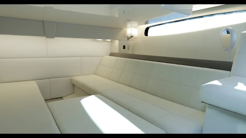 Slide: The Image of Luxurious interior of 2021 Regal 36 Grande Coupe yacht with white seating. - 31