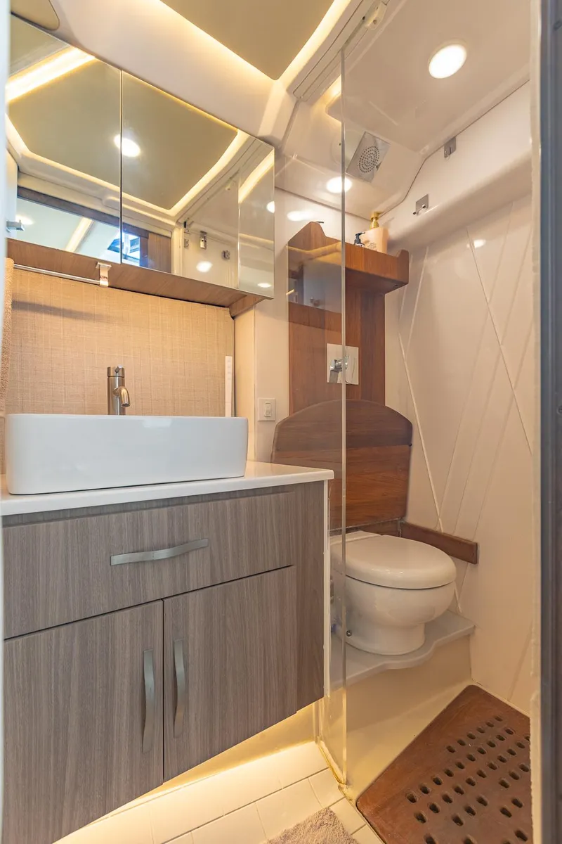 Slide: The Image of Luxurious bathroom in 2021 Regal 36 Grande Coupe yacht with modern fixtures and wood accents. - 33