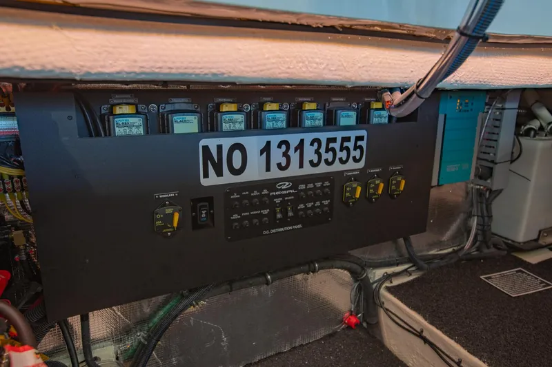Slide: The Image of Electrical panel of 2021 Regal 36 Grande Coupe boat, showing circuit breakers and wiring. - 37