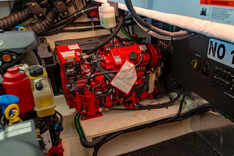 Slide: The Image of Engine room of 2021 Regal 36 Grande Coupe with red machinery and wiring. - 38