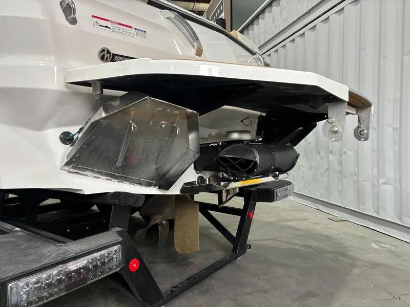 Slide: The Image of 2024 MasterCraft X24 boat rear view with advanced wake system in a storage facility. - 3