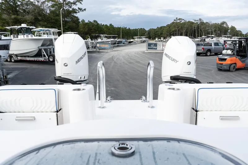 Slide: The Image of 2025 Twin Vee 280 GFX2 CC boat with dual Mercury engines in a marina. - 13