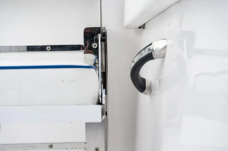 Slide: The Image of Close-up of 2025 Twin Vee 280 GFX2 CC boat interior detail, featuring a metal handle. - 20