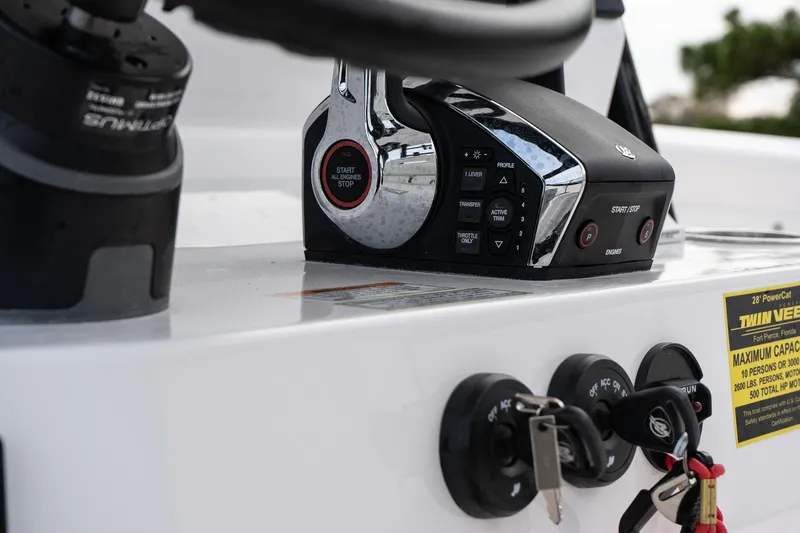 Slide: The Image of Close-up of 2025 Twin Vee 280 GFX2 CC boat controls and ignition keys. - 24