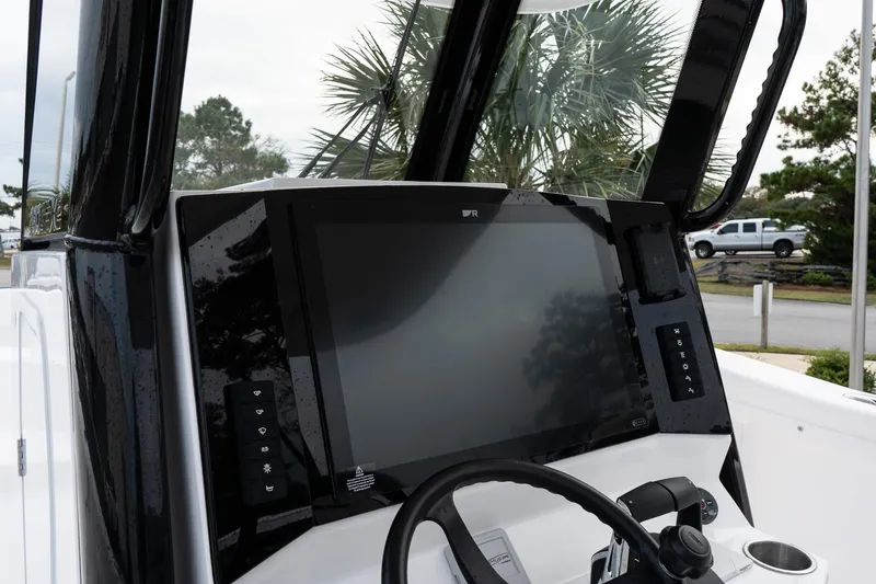Slide: The Image of 2025 Twin Vee 280 GFX2 CC boat dashboard with modern navigation display. - 26