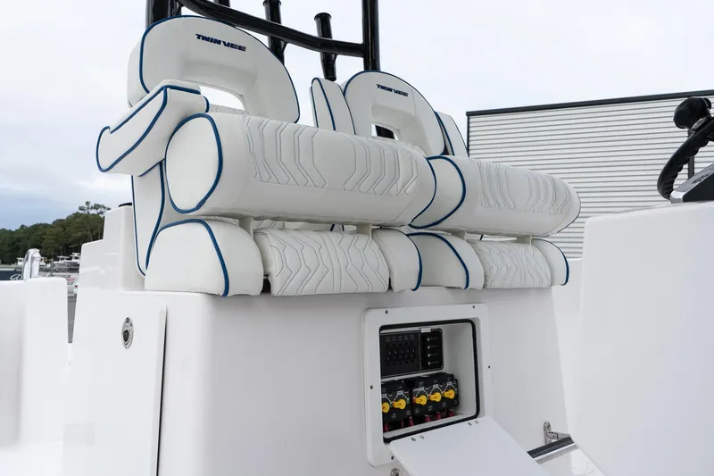 Slide: The Image of 2025 Twin Vee 280 GFX2 CC boat seating and control panel, white and blue design. - 35