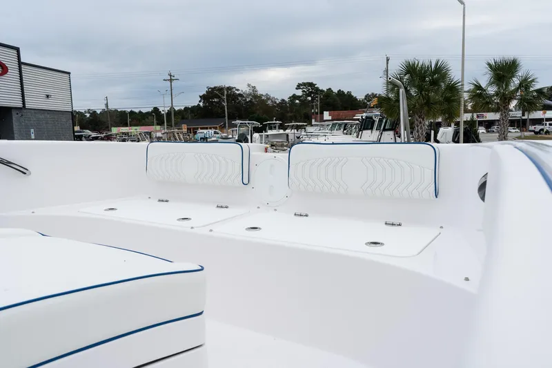 Slide: The Image of 2025 Twin Vee 280 GFX2 CC boat interior with white seating and blue accents. - 40