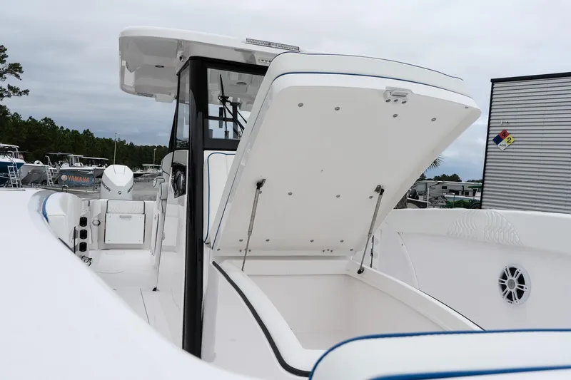 Slide: The Image of 2025 Twin Vee 280 GFX2 CC boat with open storage compartment, sleek design. - 43