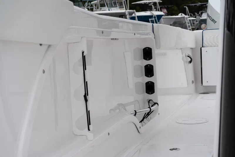 Slide: The Image of 2025 Twin Vee 280 GFX2 CC boat interior with rod holders and storage compartments. - 47