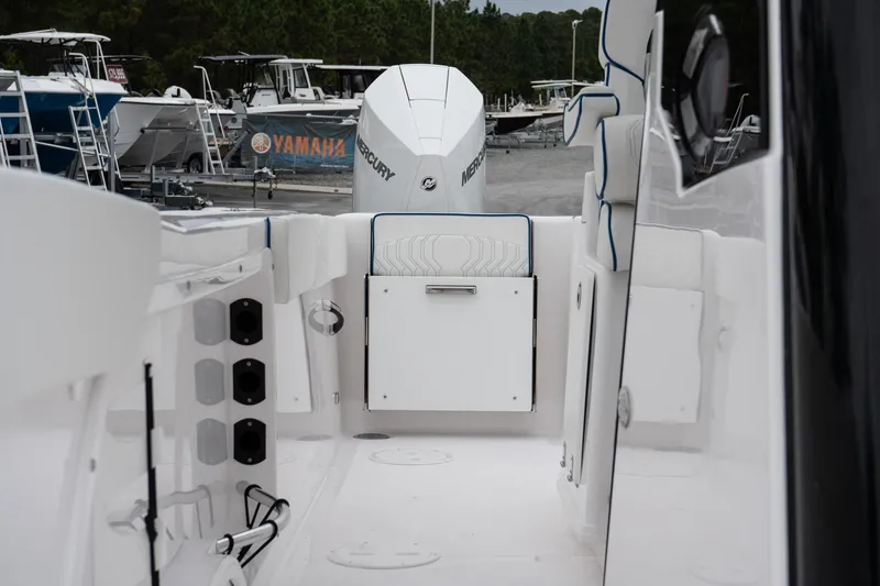 Slide: The Image of 2025 Twin Vee 280 GFX2 CC boat interior with Mercury engine, docked near Yamaha sign. - 48