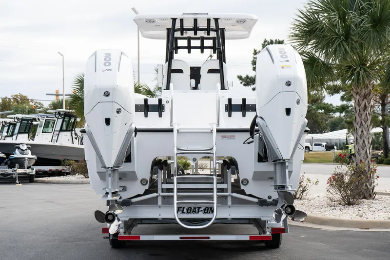 Slide: The Image of 2025 Twin Vee 280 GFX2 CC boat on trailer, rear view, dual engines. - 5