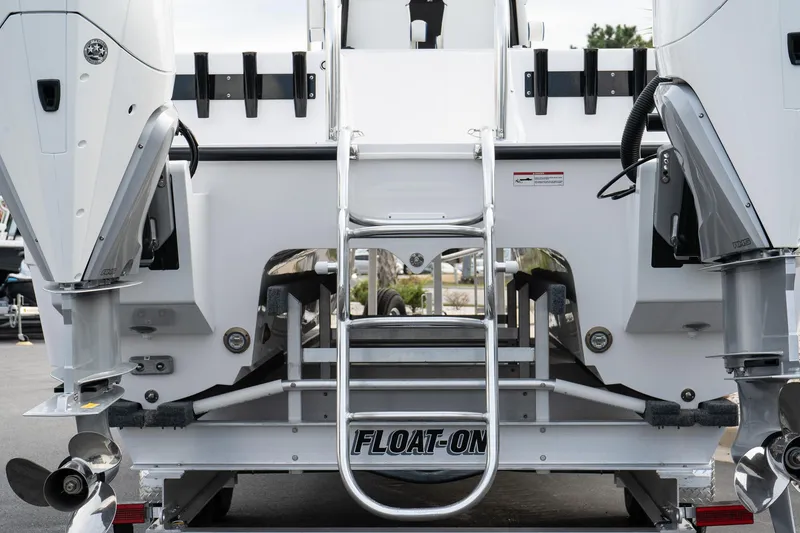 Slide: The Image of 2025 Twin Vee 280 GFX2 CC boat rear view with dual engines and ladder. - 7
