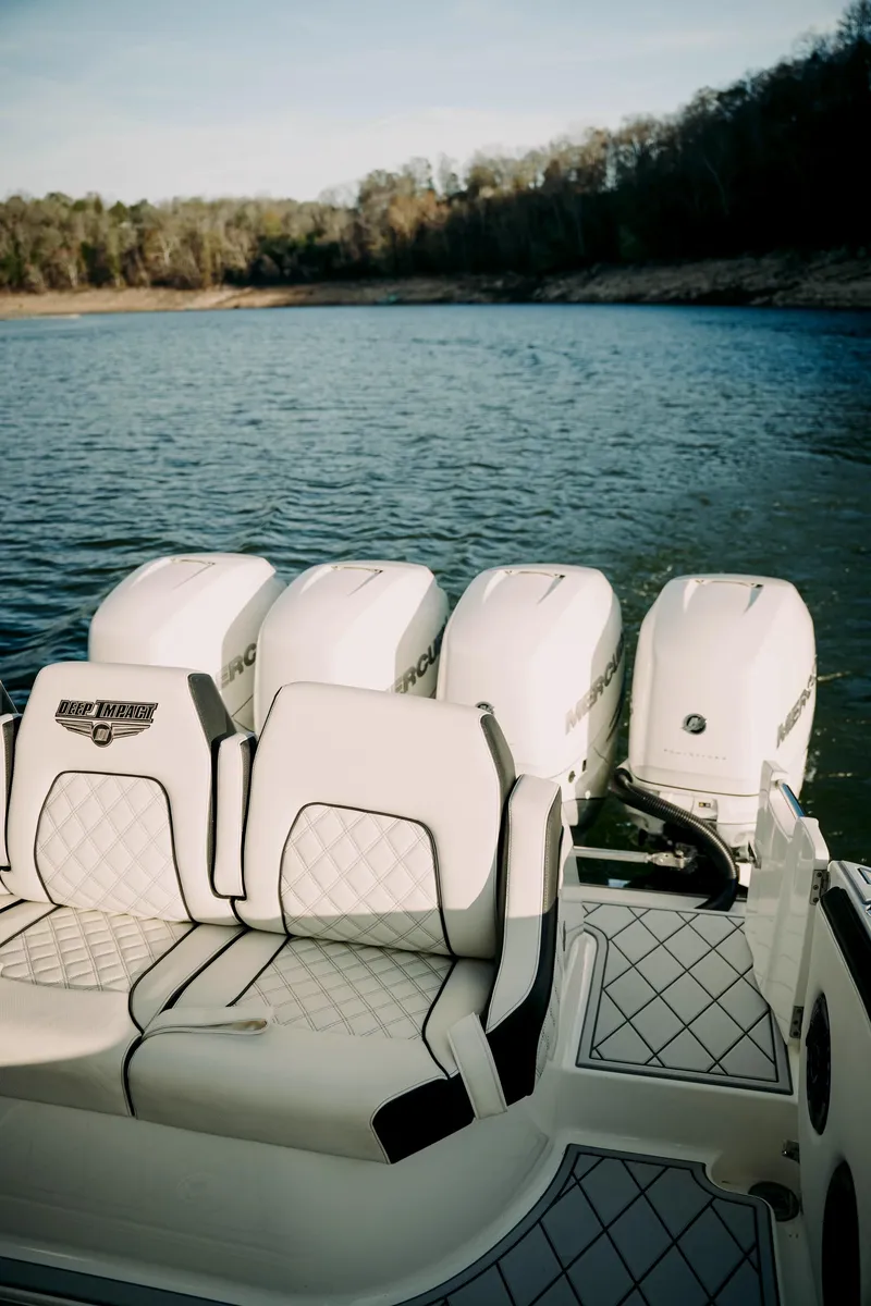Slide: The Image of 2021 Deep Impact 399 Sport boat with quad engines on a serene lake. - 24