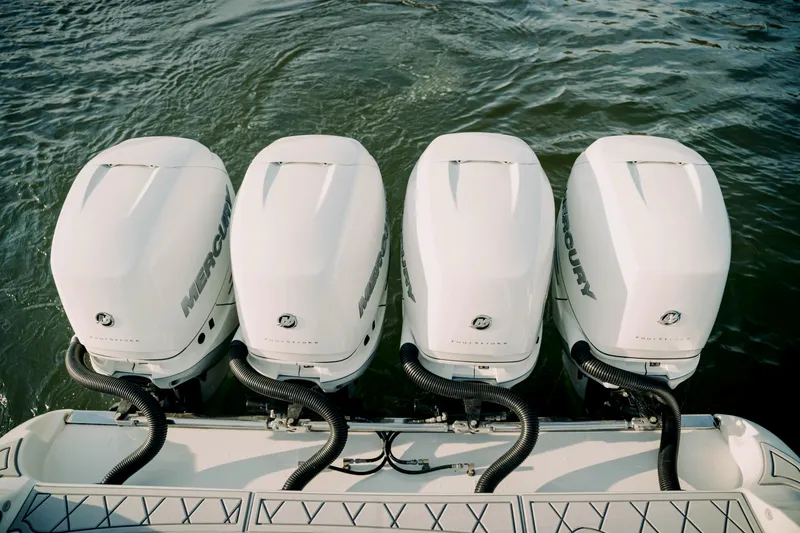 Slide: The Image of Four Mercury outboard engines on a 2021 Deep Impact 399 Sport boat. - 25