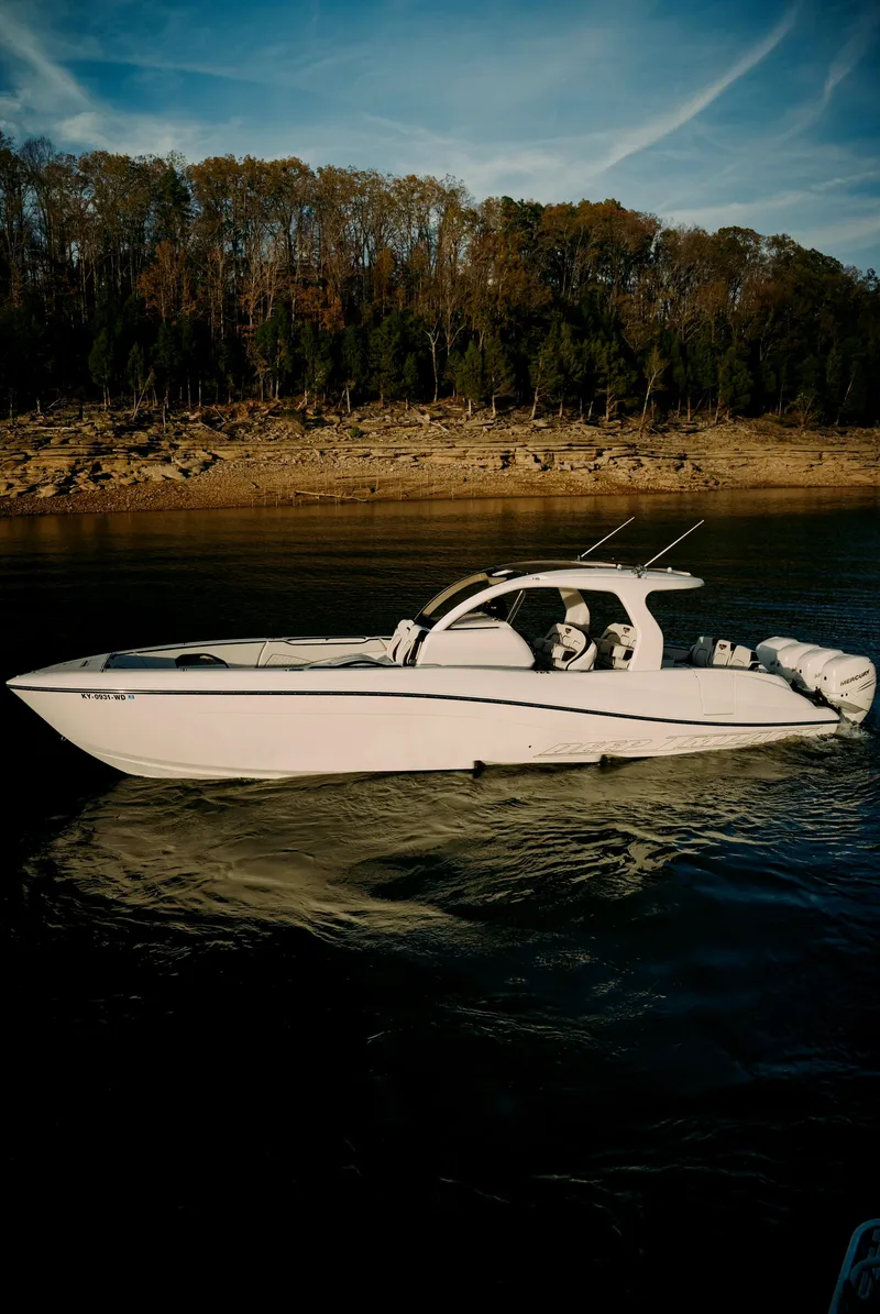 Slide: The Image of 2021 Deep Impact 399 Sport boat cruising on a serene lake. - 27