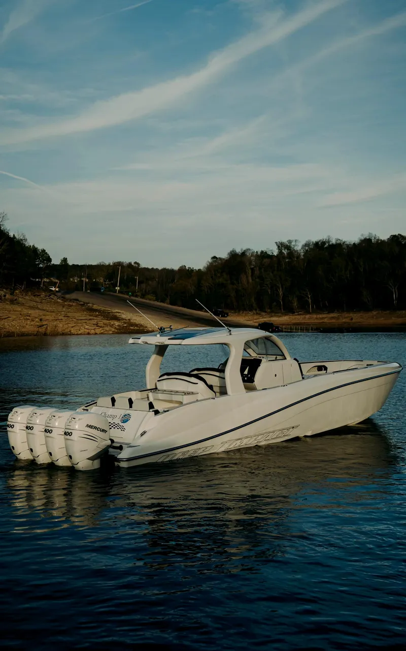 Slide: The Image of 2021 Deep Impact 399 Sport boat on a calm lake under a clear sky. - 4
