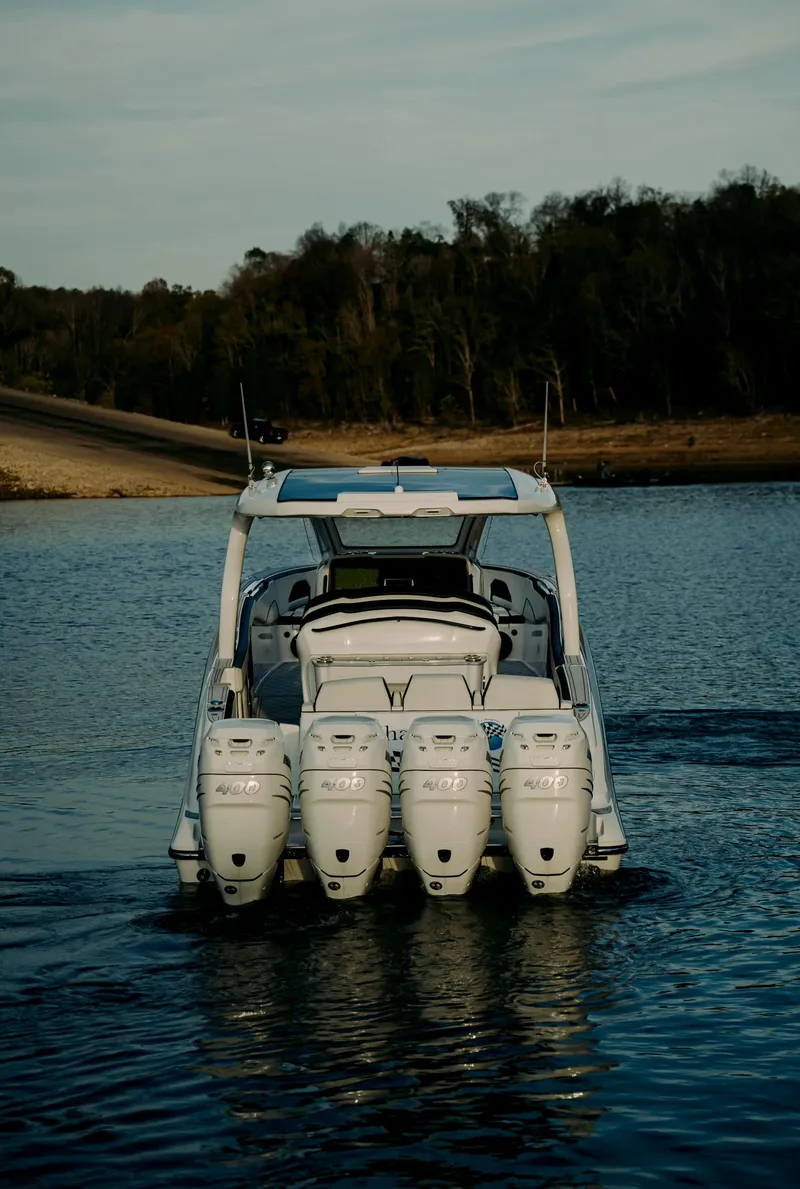 Slide: The Image of 2021 Deep Impact 399 Sport boat with multiple engines on a calm lake. - 6