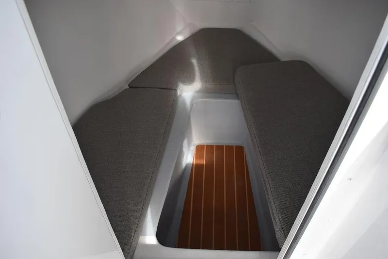 Slide: The Image of Interior cabin of 2025 Steiger Craft 23 Miami with cushioned seating and wooden flooring. - 10