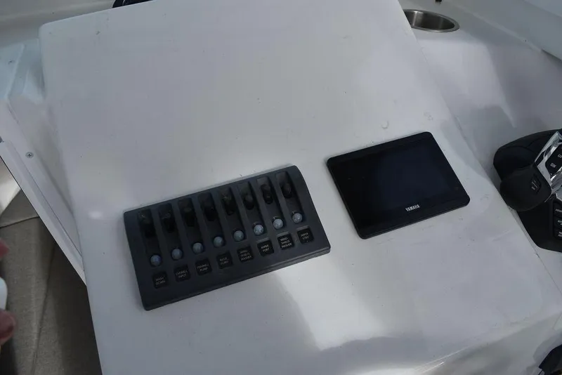 Slide: The Image of Control panel of 2025 Steiger Craft 23 Miami boat with switches and display. - 13