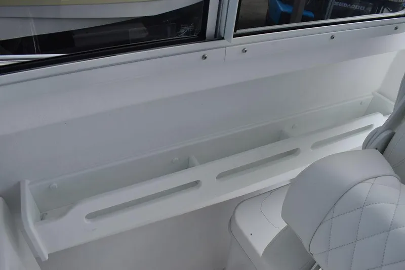 Slide: The Image of Interior of 2025 Steiger Craft 23 Miami boat, featuring white seating and storage. - 19