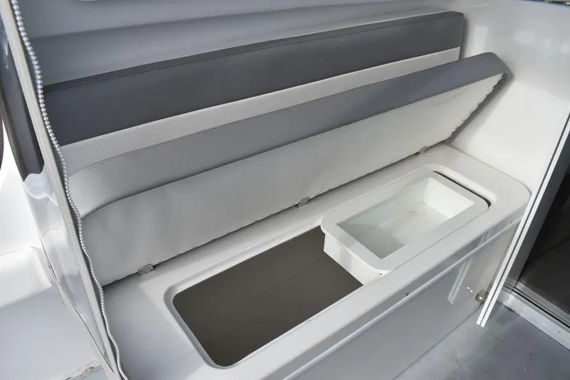 Slide: The Image of Steiger Craft 23 Miami 2025 boat storage compartment with cushioned seating. - 22