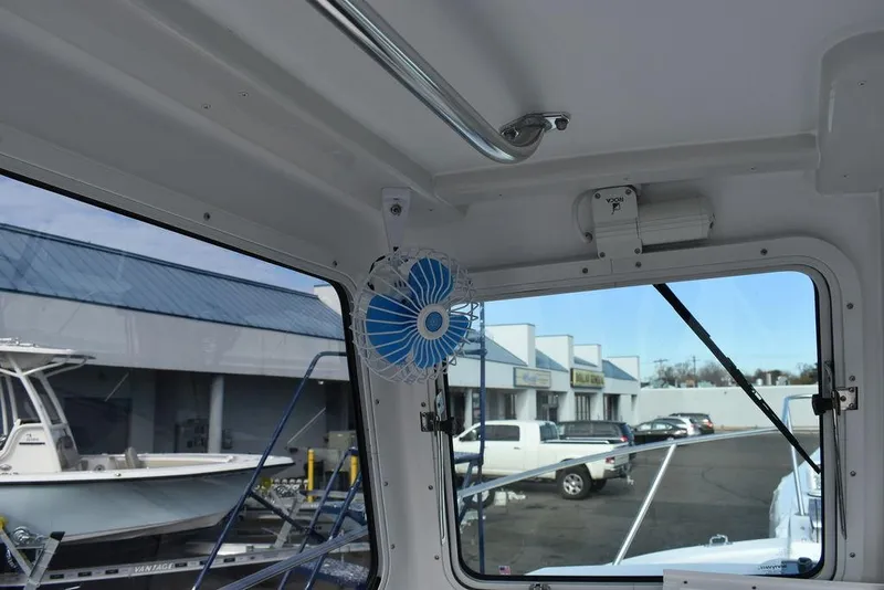 Slide: The Image of Interior view of 2025 Steiger Craft 23 Miami boat with window and fan. - 23