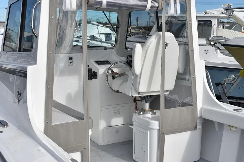 Slide: The Image of 2025 Steiger Craft 23 Miami boat interior with helm and seating. - 7