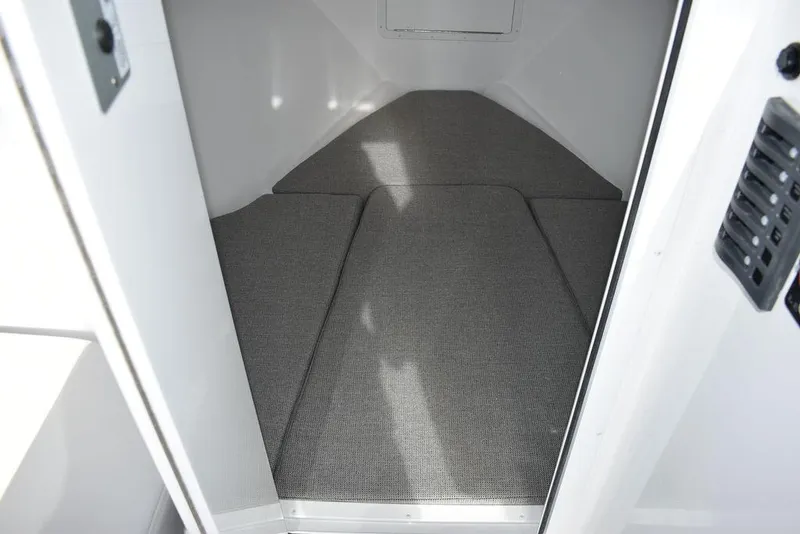Slide: The Image of Interior cabin of 2025 Steiger Craft 23 Miami boat with gray carpeting. - 9