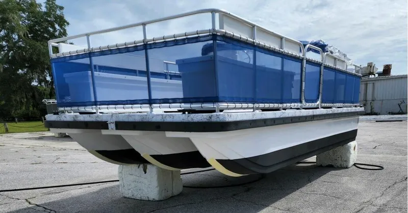 Slide: The Image of 2025 A&M Manufacturing Salty 23 pontoon boat on display outdoors. - 17