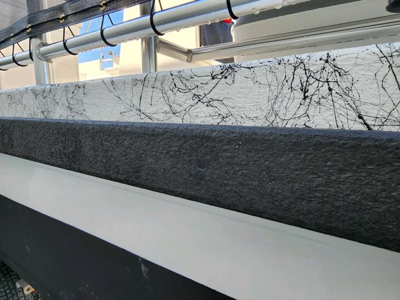 Slide: The Image of Close-up of 2025 A&M Manufacturing Salty 23 boat hull with textured surface. - 3