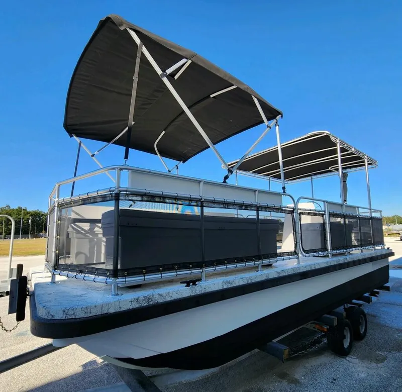 Slide: The Image of 2025 A&M Manufacturing Salty 23 pontoon boat with dual canopies on a trailer. - 5