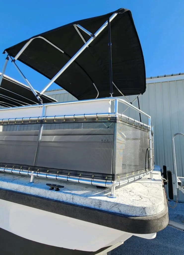Slide: The Image of 2025 A&M Manufacturing Salty 23 boat with canopy, docked under clear blue sky. - 6