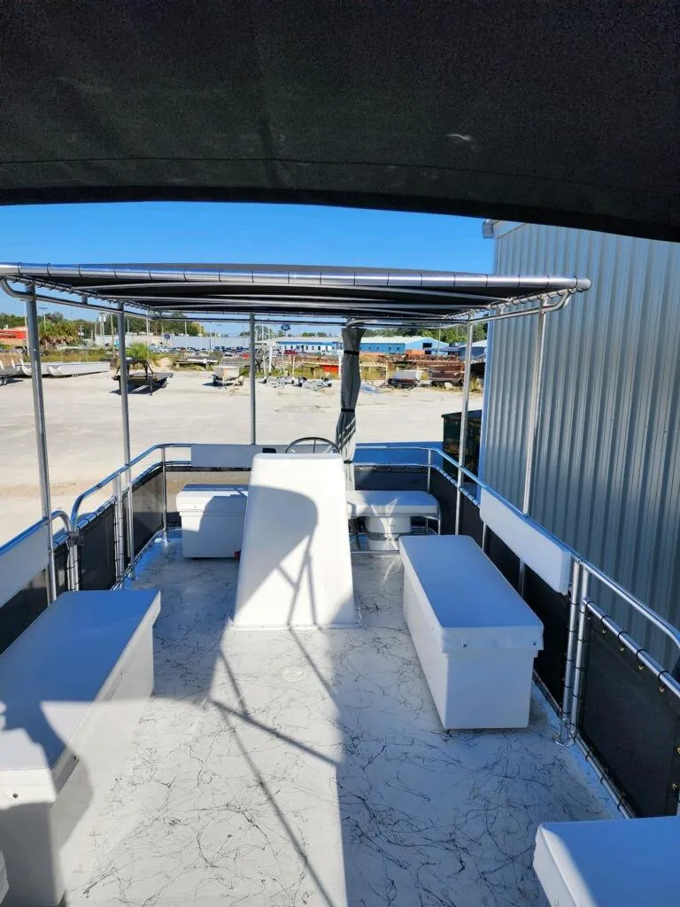 Slide: The Image of 2025 A&M Manufacturing Salty 23 boat interior with seating and canopy. - 8