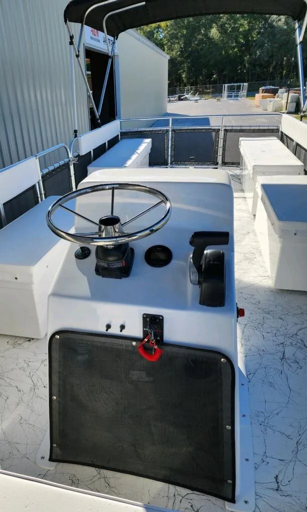 Slide: The Image of 2025 A&M Manufacturing Salty 23 boat interior with steering console and seating. - 9