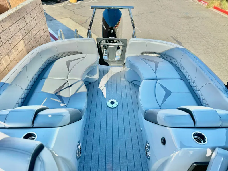 Slide: The Image of 2025 Manitou 23 LX RFXW boat interior with luxurious seating and modern design. - 10