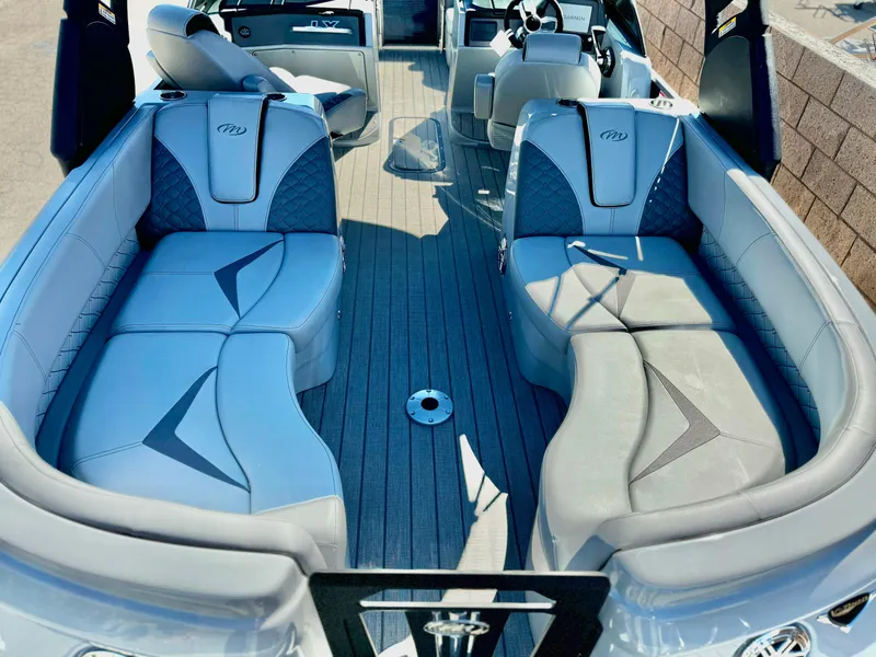 Slide: The Image of 2025 Manitou 23 LX RFXW pontoon boat interior with stylish seating and modern design. - 11