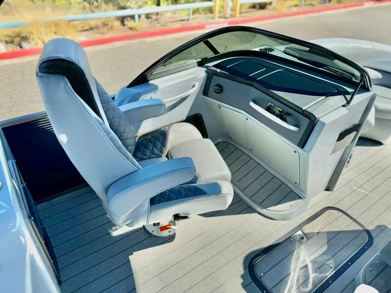 Slide: The Image of 2025 Manitou 23 LX RFXW boat interior with modern helm and seating. - 12