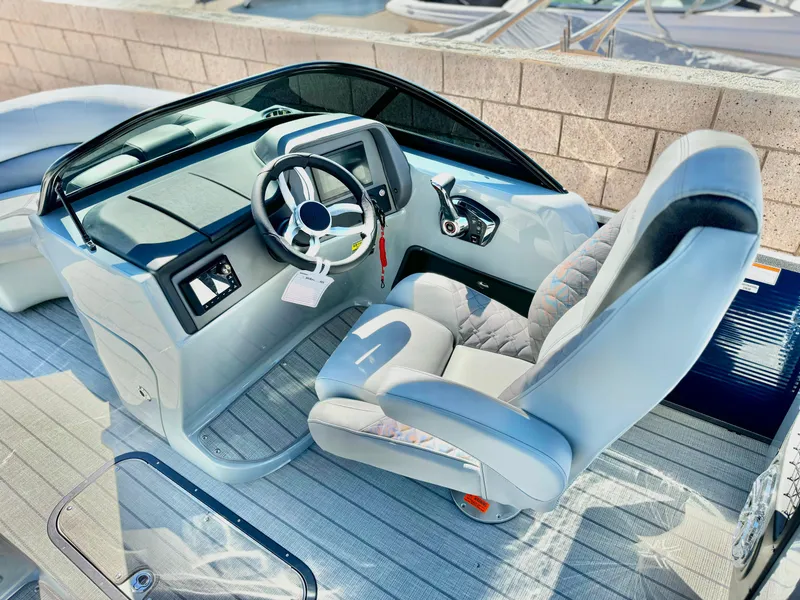 Slide: The Image of 2025 Manitou 23 LX RFXW boat cockpit with modern steering and controls. - 13