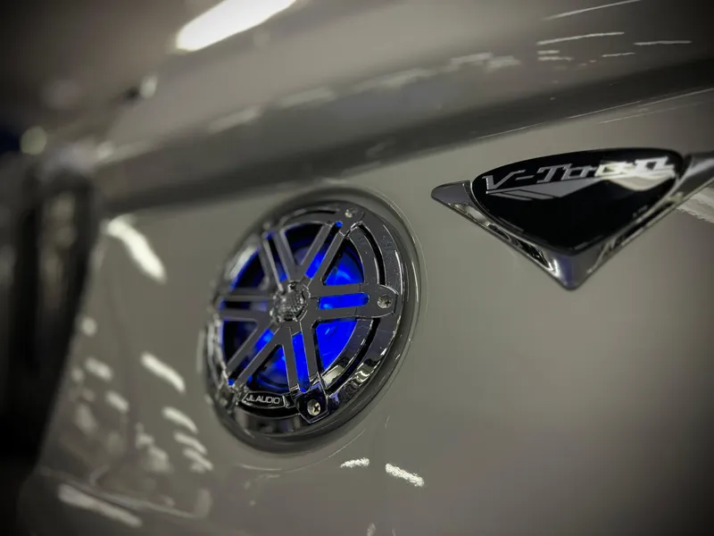 Slide: The Image of 2025 Manitou 23 LX RFXW boat with illuminated speaker and V-Toon logo. - 30